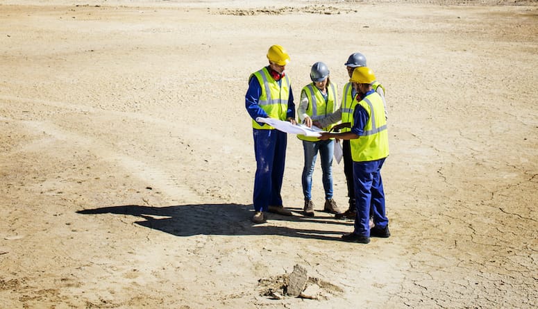 Team Examining Blueprint at Quarry