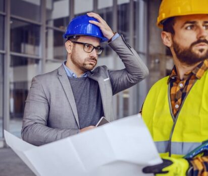 Architect & Worker Looking at Errors